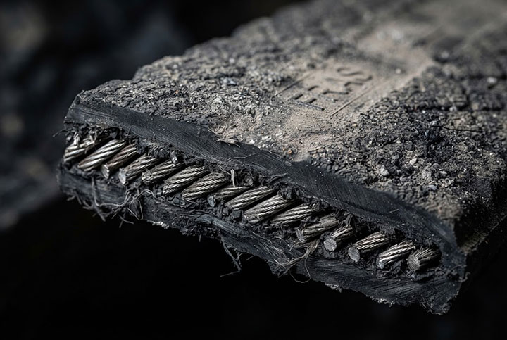 Cross-section view of a Flame-Resistant Anti-Static (FRAS) mining conveyor belt, showing steel cord reinforcement and wear-resistant rubber cover.